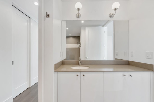 bathroom with vanity and wood finished floors