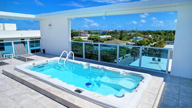 view of pool featuring hot tub deck surround