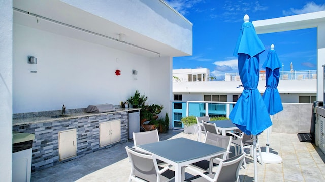 view of patio featuring outdoor dining area and exterior kitchen