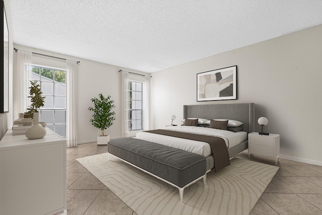 bedroom featuring baseboards, a textured ceiling, and light tile patterned flooring