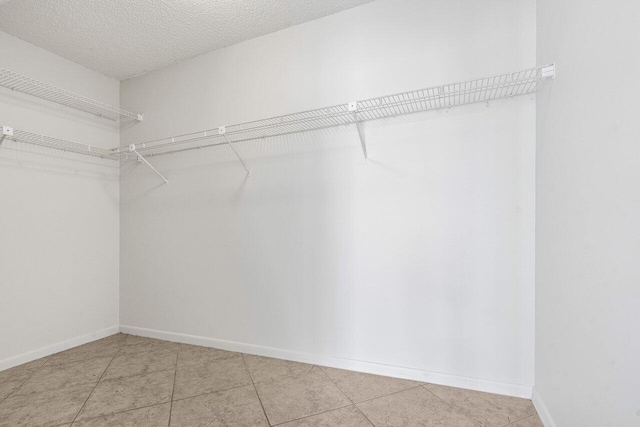 spacious closet with light tile patterned flooring