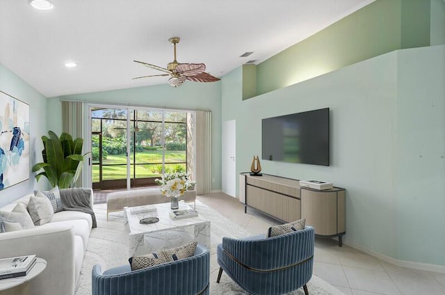 living area featuring lofted ceiling, ceiling fan, baseboards, and light tile patterned floors