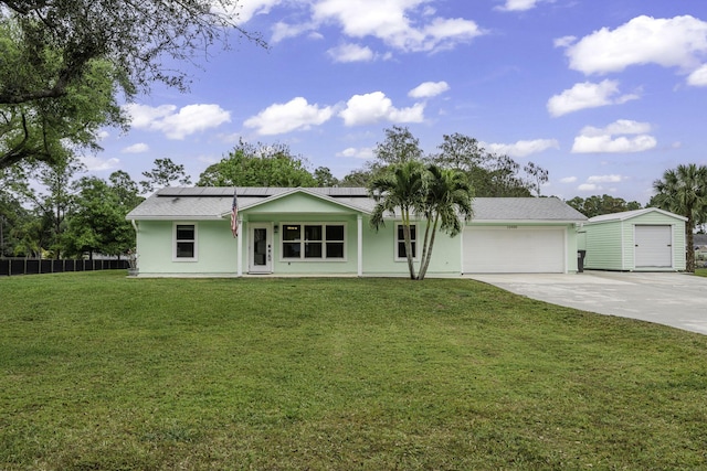 ranch-style house with a garage, solar panels, fence, concrete driveway, and a front yard