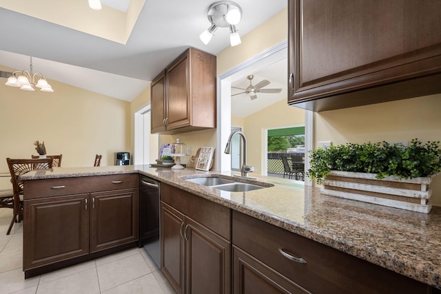 kitchen with dishwashing machine, light stone counters, a peninsula, vaulted ceiling, and a sink