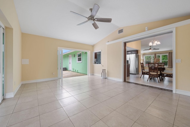 spare room featuring lofted ceiling, visible vents, ceiling fan, and light tile patterned flooring