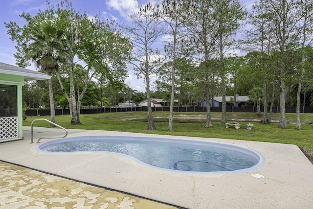 view of swimming pool with a lawn, a patio area, and fence