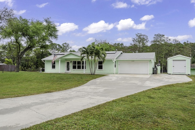 ranch-style house with a garage, concrete driveway, a storage unit, roof mounted solar panels, and a front lawn