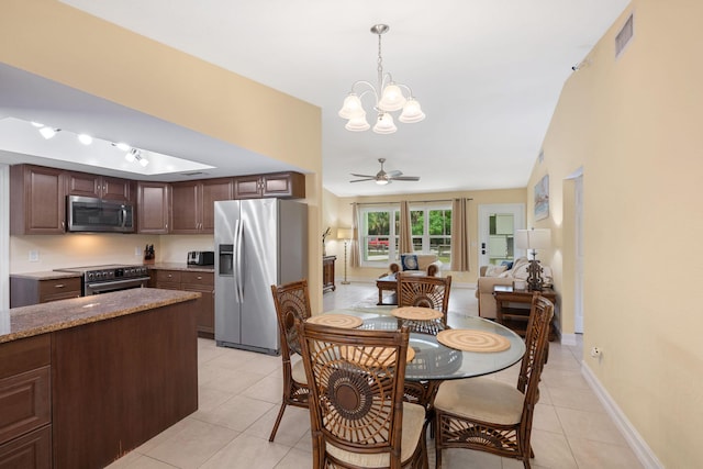 dining room with light tile patterned floors, ceiling fan with notable chandelier, visible vents, and baseboards