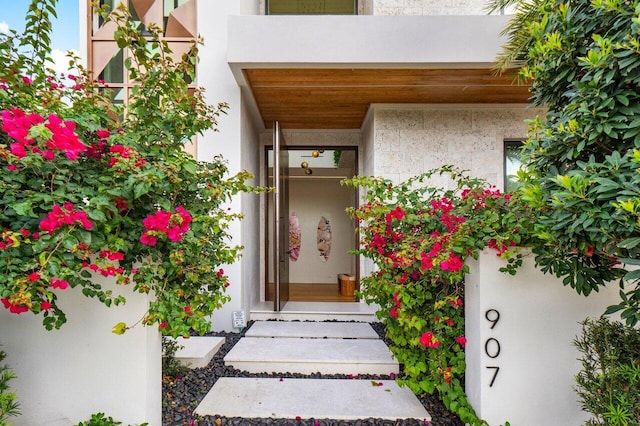 entrance to property with stucco siding