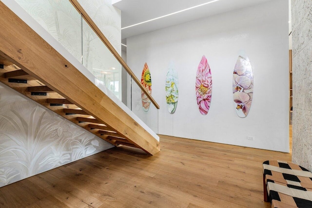 staircase with hardwood / wood-style floors