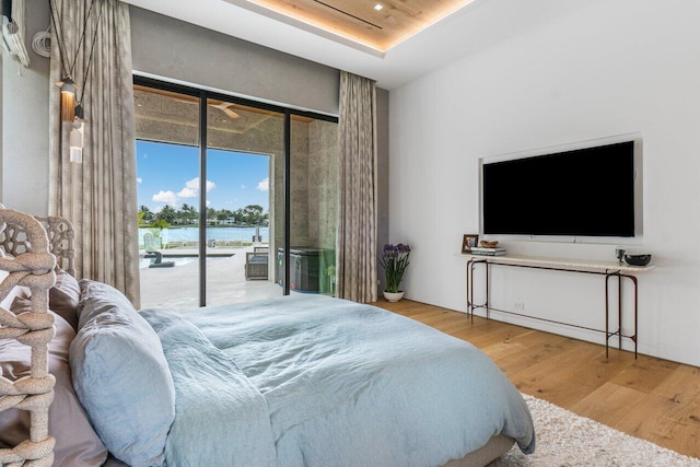 bedroom featuring access to exterior and wood finished floors