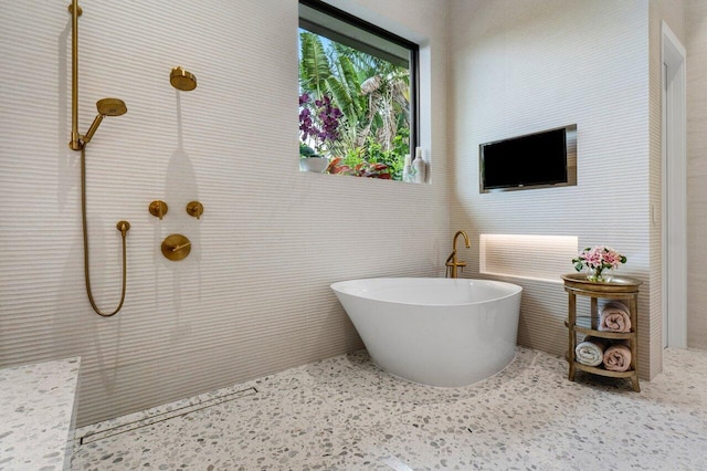 full bathroom featuring a soaking tub and a tile shower