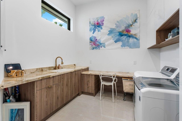 laundry area featuring laundry area, independent washer and dryer, and a sink