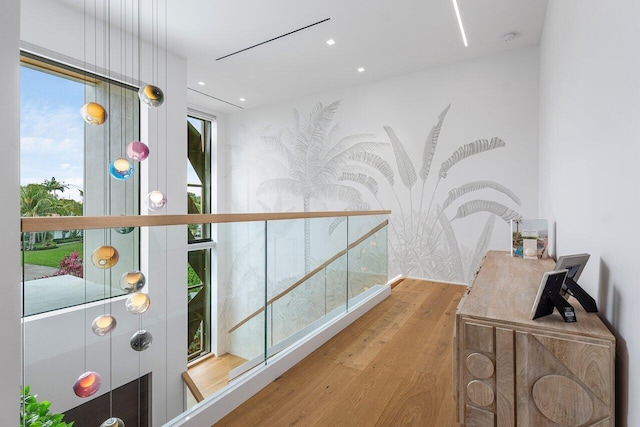 corridor with wood finished floors and recessed lighting