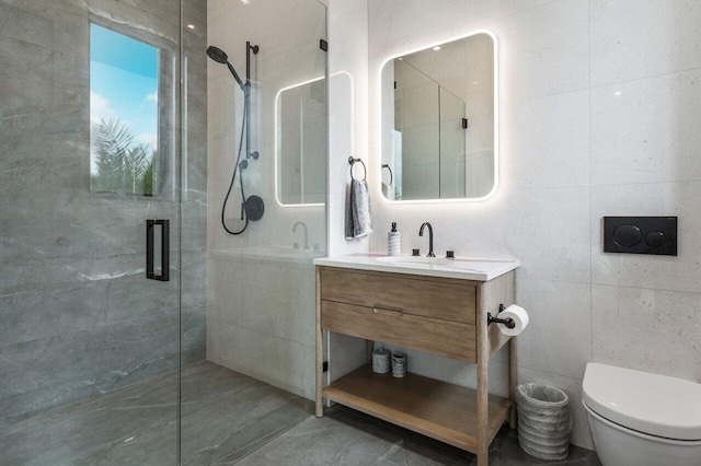 full bathroom with toilet, a stall shower, vanity, and tile walls