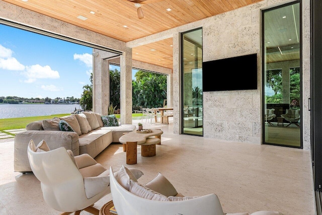 view of patio with a water view and an outdoor living space