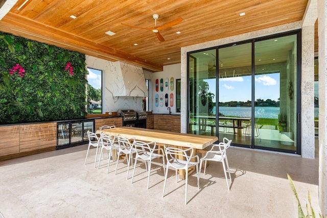 view of patio / terrace with area for grilling, ceiling fan, grilling area, a water view, and outdoor dining area