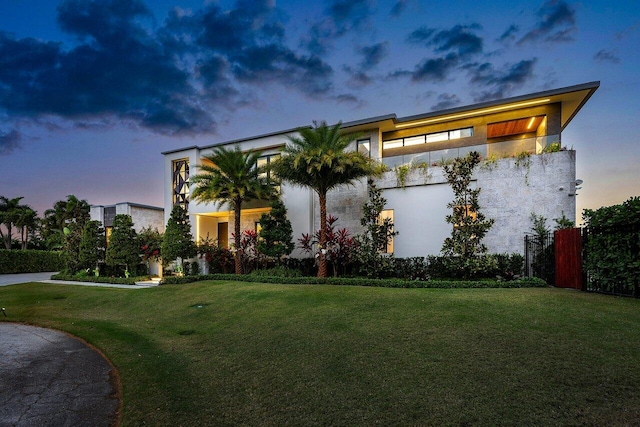 modern home with a front yard and stucco siding