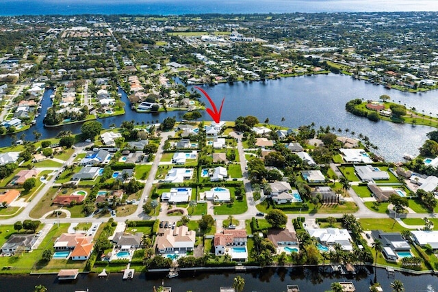 birds eye view of property featuring a water view and a residential view