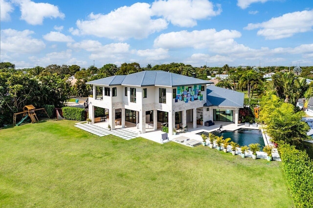 back of house featuring an outdoor pool, a lawn, a balcony, a patio area, and a playground