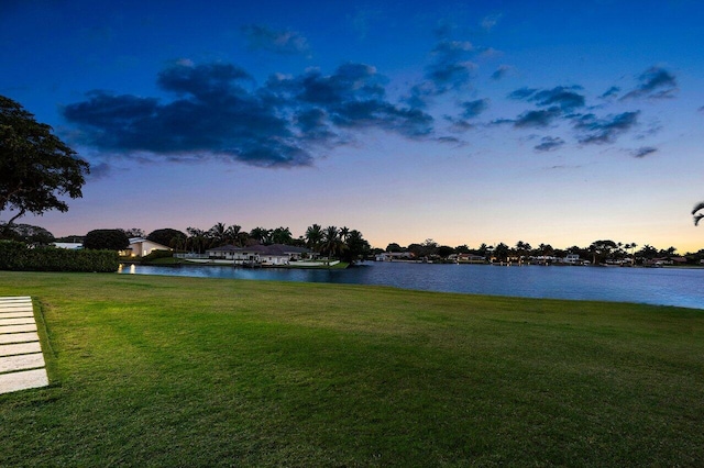 yard at dusk with a water view