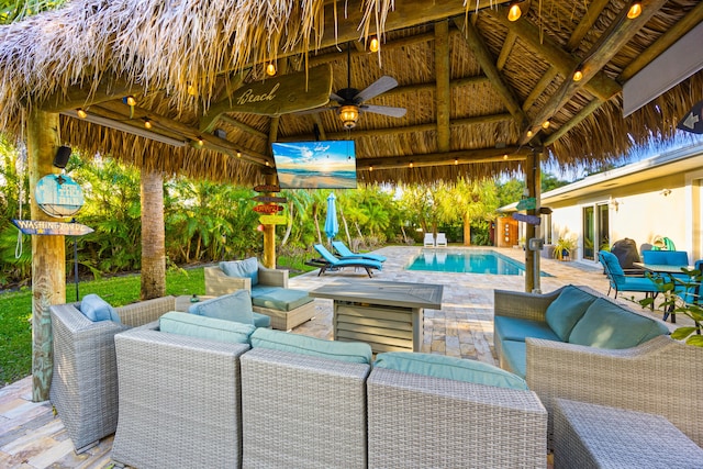 view of patio featuring a ceiling fan, outdoor lounge area, an outdoor pool, and a gazebo