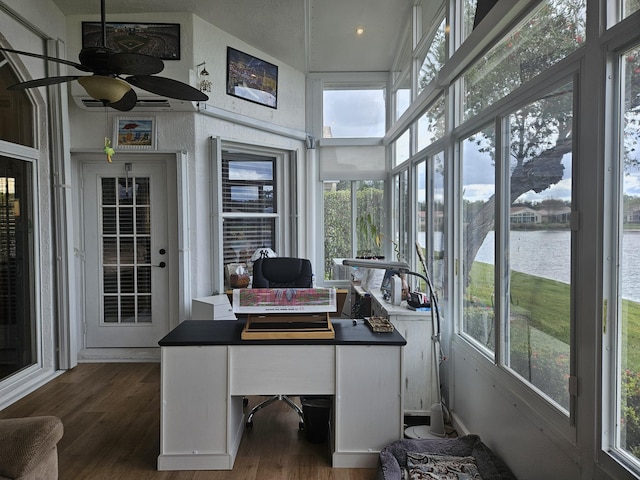 office space featuring a water view, dark wood-style floors, a high ceiling, and a ceiling fan