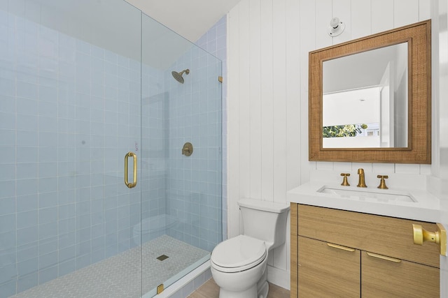 bathroom with vanity, toilet, and a stall shower
