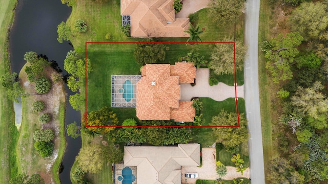 birds eye view of property with a water view