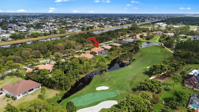 bird's eye view with golf course view, a water view, and a residential view