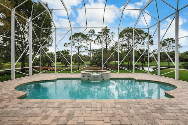 view of swimming pool featuring a patio area, a lanai, and a pool with connected hot tub