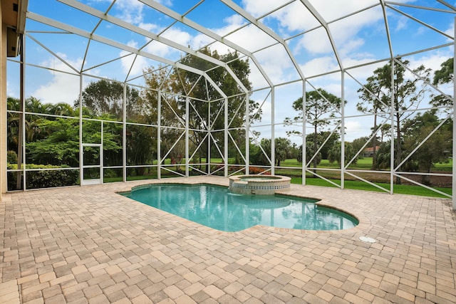 view of pool with a pool with connected hot tub, a lanai, and a patio