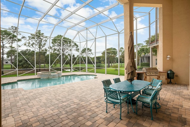 view of pool with glass enclosure, a pool with connected hot tub, exterior kitchen, grilling area, and a patio area