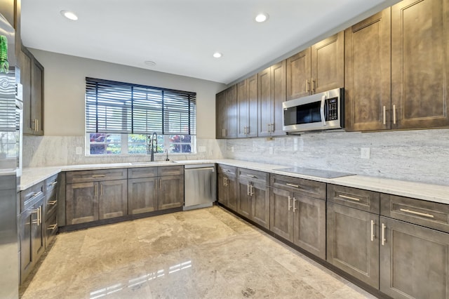 kitchen with tasteful backsplash, stainless steel appliances, a sink, and recessed lighting