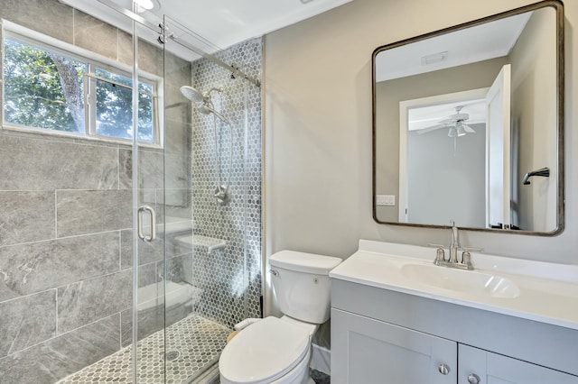 bathroom featuring visible vents, toilet, a ceiling fan, a stall shower, and vanity