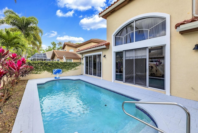 view of swimming pool featuring a fenced in pool, glass enclosure, and fence