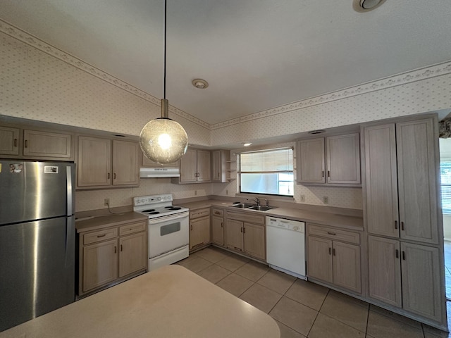 kitchen featuring decorative light fixtures, light countertops, white appliances, under cabinet range hood, and wallpapered walls