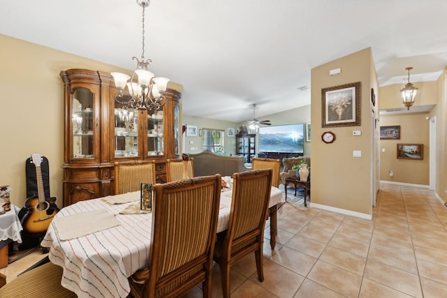 dining area featuring ceiling fan with notable chandelier, lofted ceiling, baseboards, and light tile patterned floors