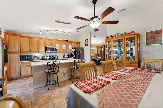 dining space with a toaster, visible vents, ceiling fan, and light tile patterned floors