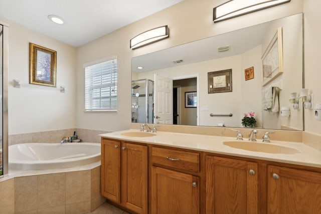 bathroom with double vanity, a stall shower, a sink, and a bath