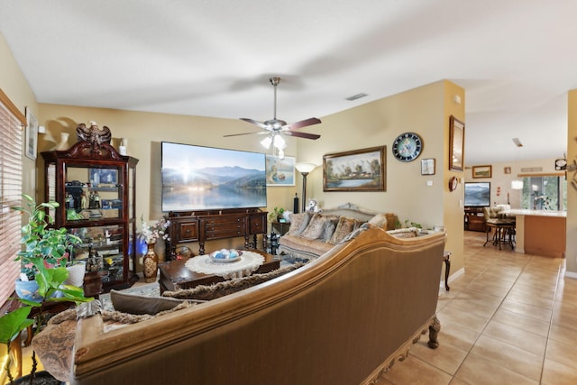 living area featuring visible vents, ceiling fan, and light tile patterned floors