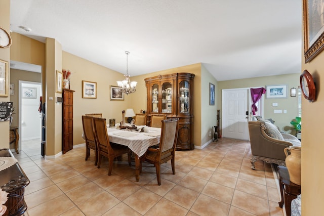 dining space with light tile patterned floors, baseboards, and an inviting chandelier