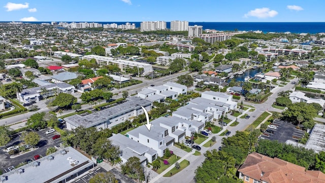 birds eye view of property with a water view and a view of city