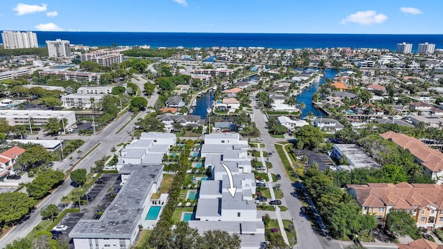 drone / aerial view featuring a view of city and a water view
