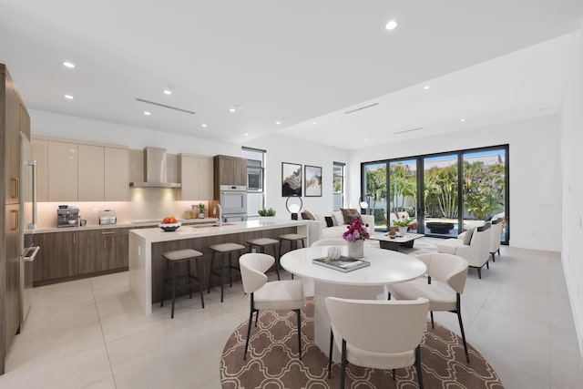 dining room with recessed lighting and light tile patterned floors