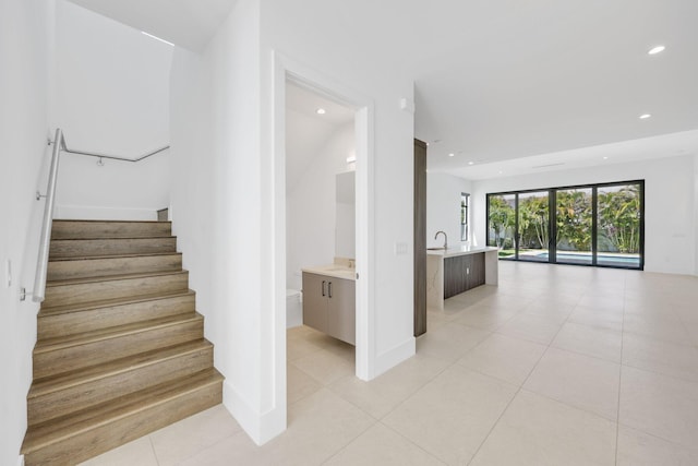 staircase featuring recessed lighting, tile patterned floors, and baseboards