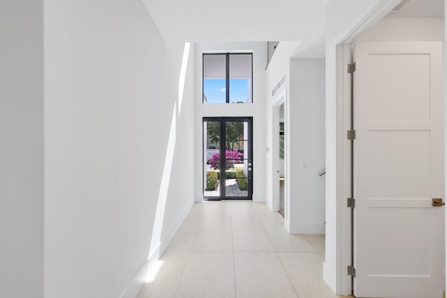 foyer entrance with baseboards and light tile patterned floors