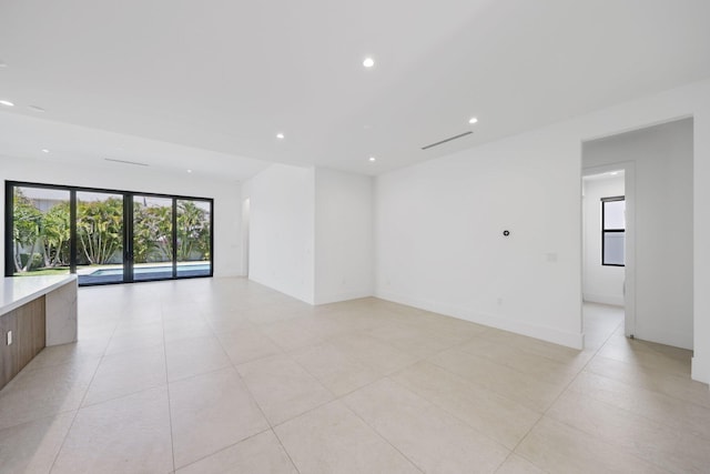 spare room with recessed lighting and light tile patterned floors