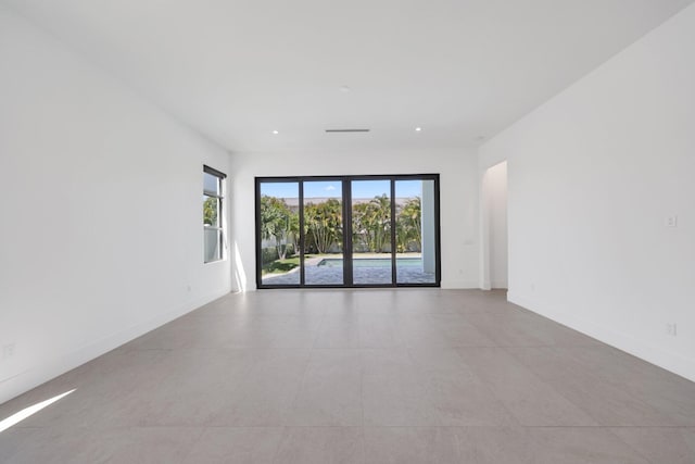 spare room featuring baseboards and recessed lighting