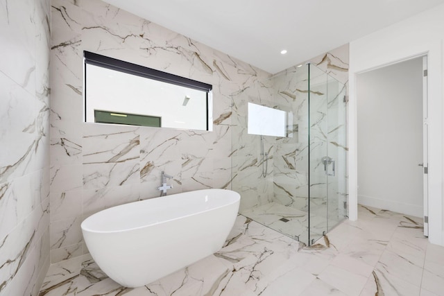 full bathroom with a freestanding tub, marble finish floor, and a marble finish shower